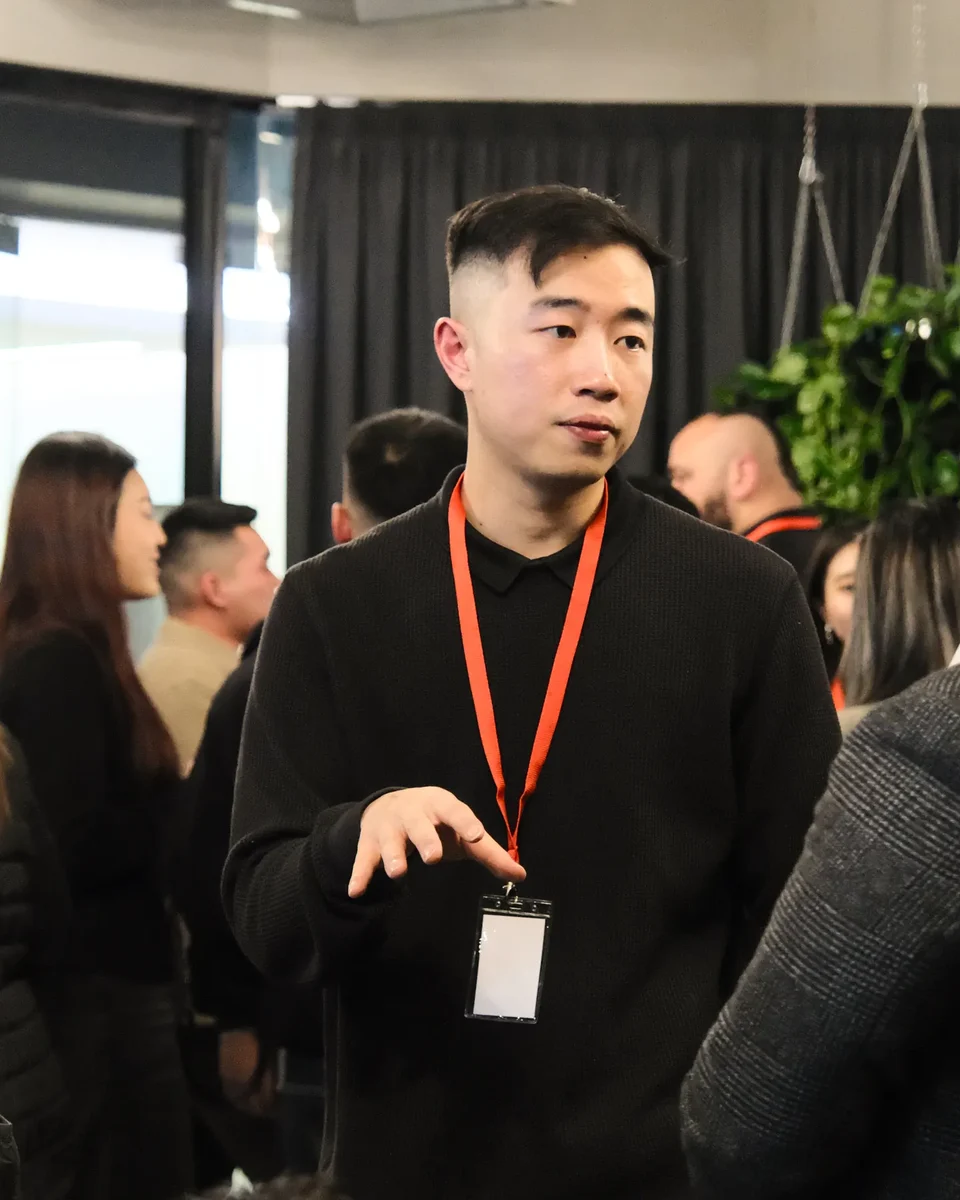 Terence Mok talking with members at a BNB Success event.